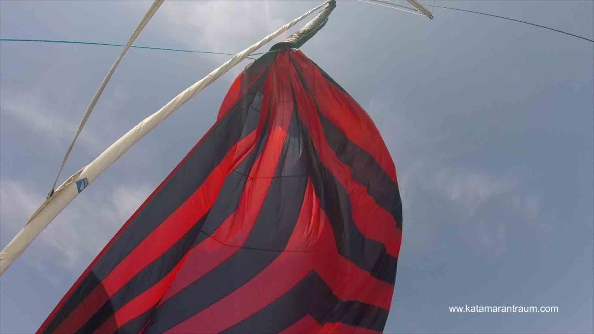 We pull down the Wingaker sail into the cover