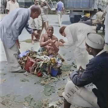 Baidul urging Shastri Kher,a mast, to accept prasad from Baba1 March 1948. Image colored by Jim Kirkpatrick,