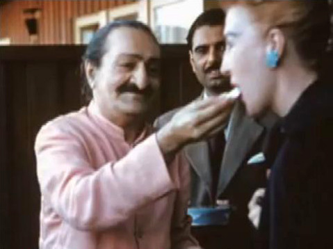 1958 ; Holiday Lodge Hotel, San Francisco, USA. Baba giving sweets to Marion with Eruch Jessawala looking on.