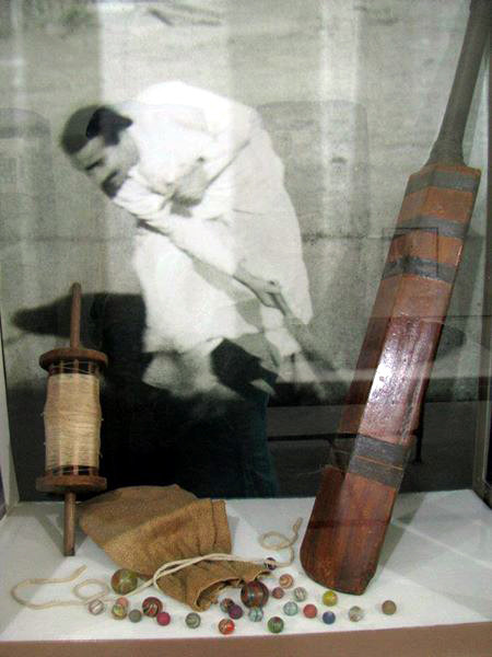 Display case at Beloved Archives, New Gersey showing Meher Baba's cricket bat, marbles and kite string - courtesy of The Glow magazine