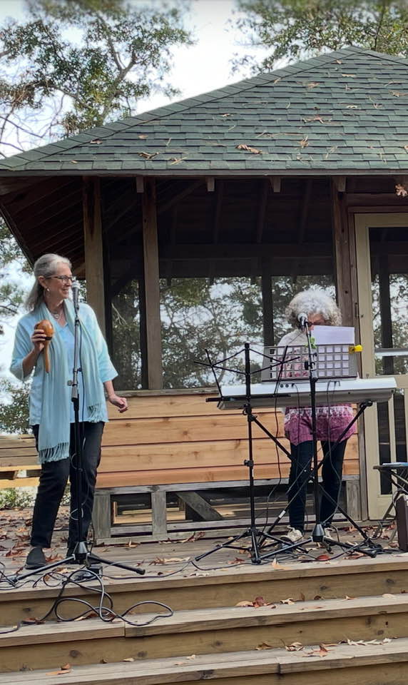 Debbie on stage singing along with Bobbi Berstein at the Meher Center, Myrtle Beach, SC.