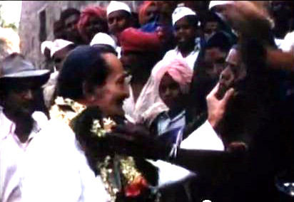 Baba being garlanded by a local woman