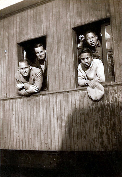 Train travelling in China - Herbert is on the left-rear with unknown man.
