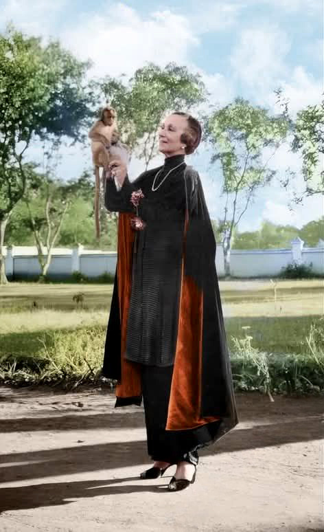 Norina with a pet monkey in India. Image has been colourized.
