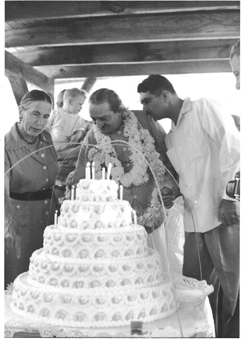 1958 : Meher Baba at the Meher Center, Myrtle Beach, SC. Baba is holding Eruch Jessawala's hand for support. Kitty Davy is pointing out some details of the cake. In the background is Harold Rudd holding is son Raphael.