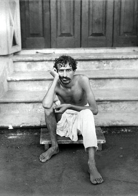 Meher Baba sitting on the steps of Manzil-e-Meem in 1922 - Courtesy of MN Collection