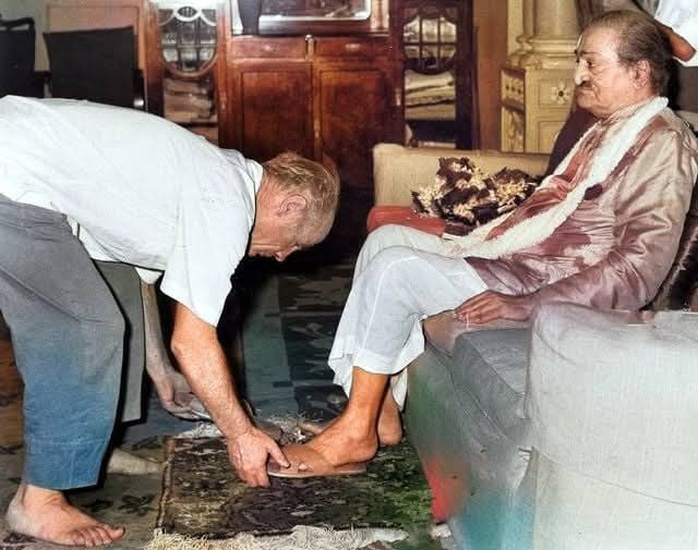 Francis removes the sandals from Baba's feet. COLOURIZATION.