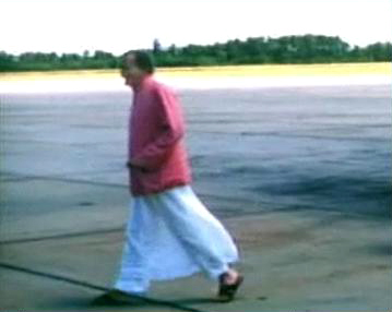 1956 : Meher Baba walking across the tarmac at Wilmington Airport, NC., after arriving from New York, on his way to Myrtle Beach, SC. Image captured by Anthony Zois from a film by Sufism Reoriented.