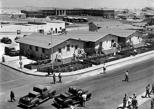 A view of the Dhahran Headquarters Office Building is in the background, 1952