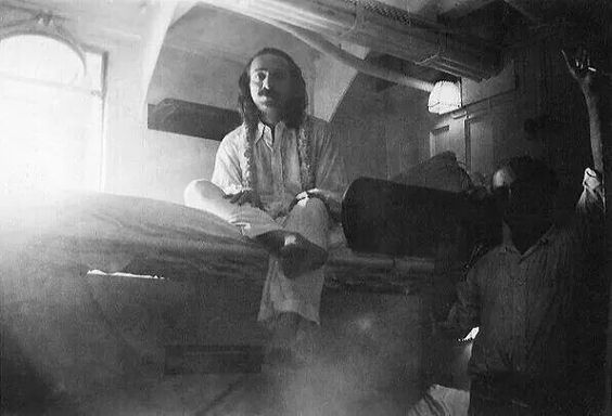 Meher Baba in his cabin with Kaka Baria. Ship is unknown. Full image.