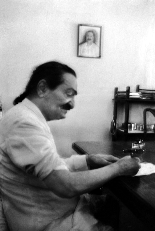 Meher Baba signing front pages of God Speaks - 18th March 1955 in Satara, India. Photo taken by Mani.