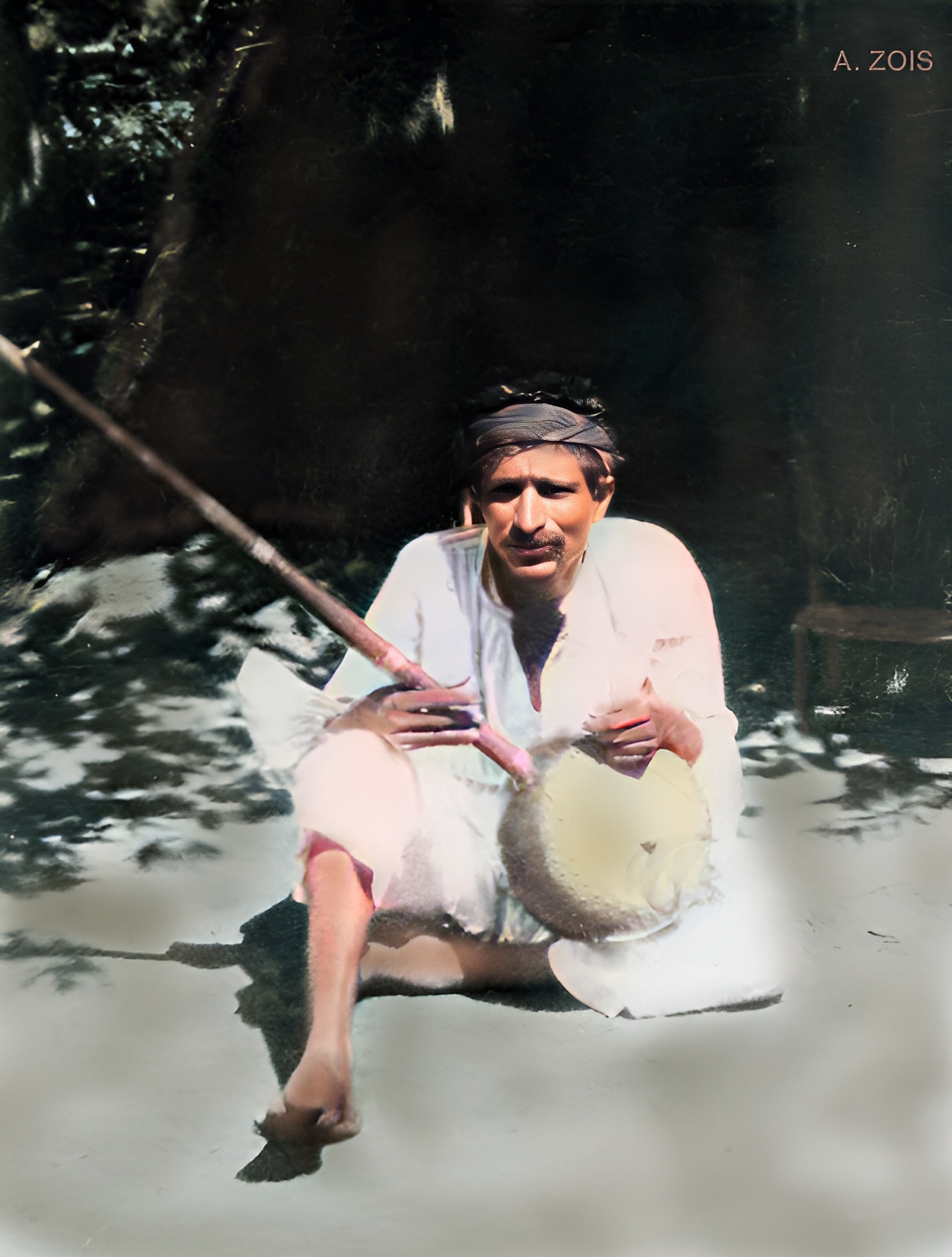 1922 : Poona, India. Meher Baba playing an Indian instrument outside his thatched hut. Image rendering by Anthony Zois.