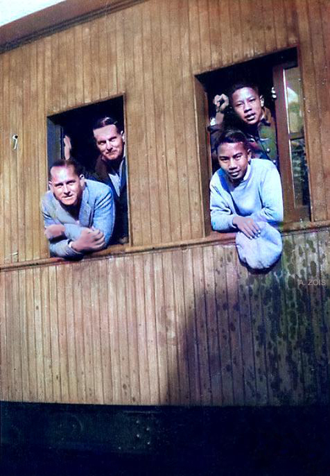 Train travelling in China - Herbert is on the left-rear with unknown man. Image colourized by Anthony Zois.