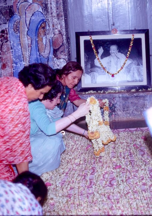 1971-Mehera, Mani & Arnavaz placing garlands for Baba. Coutesy of the Clive Adamas Photo Achive
