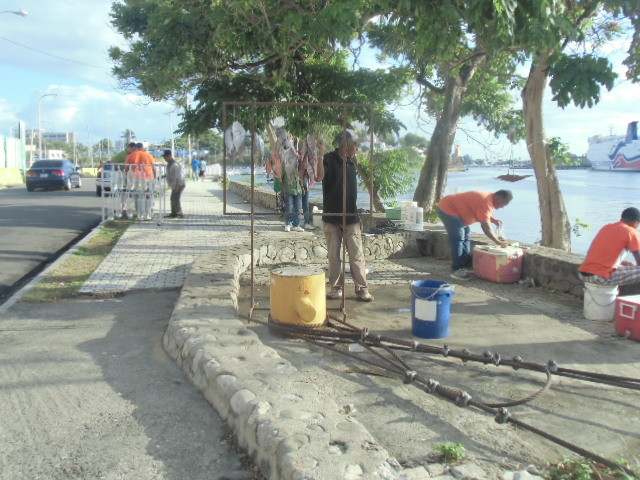 Des pêcheurs qui vendent sur le trottoir présentant le poisson sur des fils