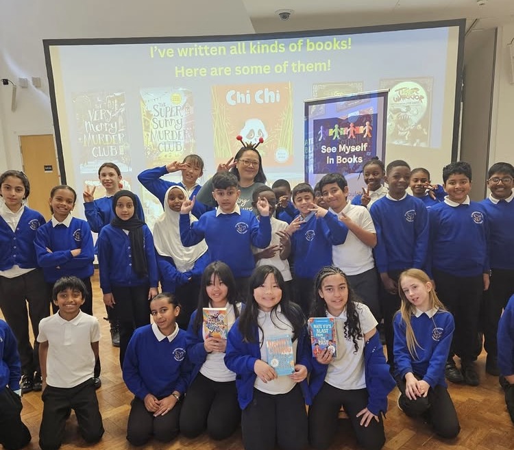 Children and author holding her book 