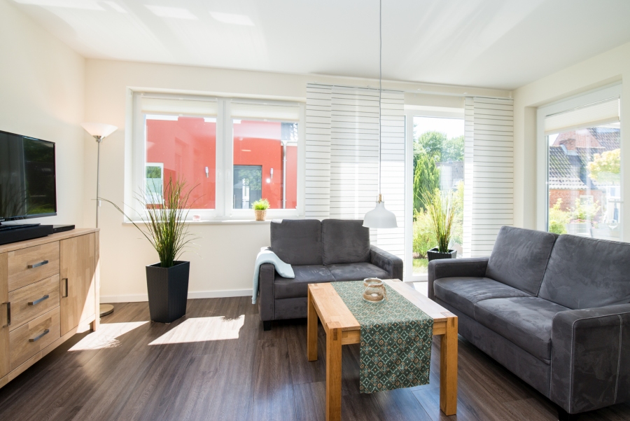 Exklusiver Wohnraum mit Kamin und komfortabler Sitzecke in einem Ferienhaus von fehmarn-mein-urlaub.de auf Fehmarn.