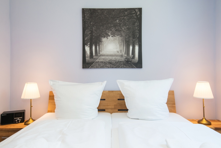 Exklusives Doppelbett mit zwei getrennten Matratzen und hochwertiger Bettwäsche im Schlafzimmer einer Ferienwohnung von fehmarn-mein-urlaub.de.