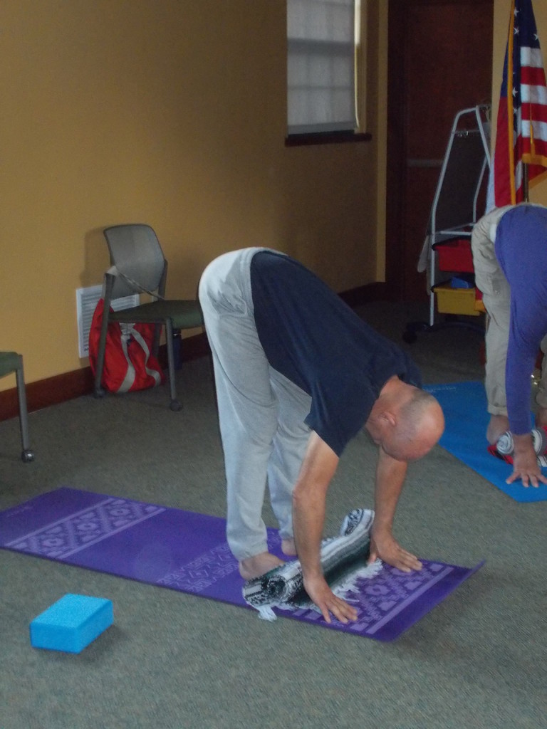 Don is demonstrating constructive forward folds with the toes up on the blanket without hyperextending his knees! (He is using his calve muscles to make sure he is not hyperextending. 