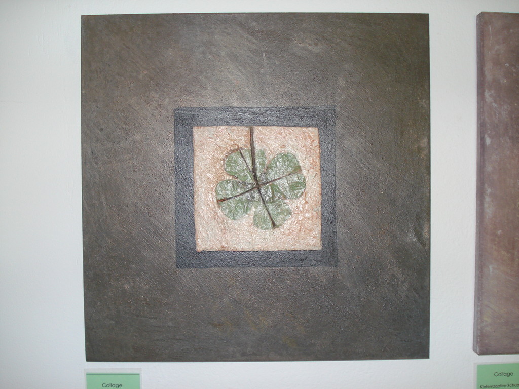 Collage mit Blatteinschluss in Beton