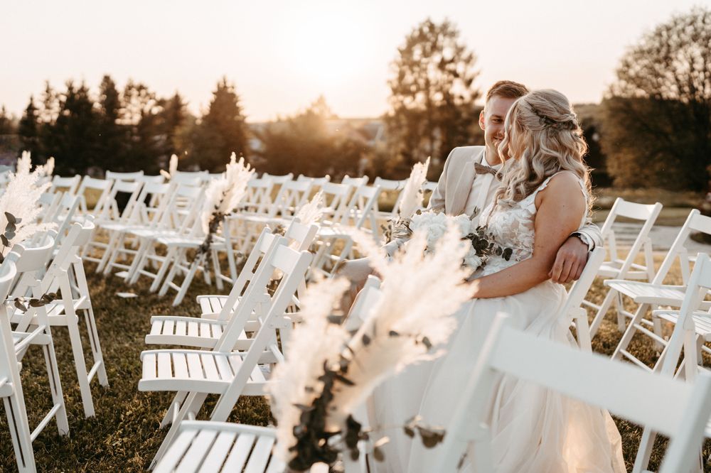 Hochzeitsfotografie im Erzgebirge: Authentische Emotionen des Paares auf dem Feld vor der Tenne.