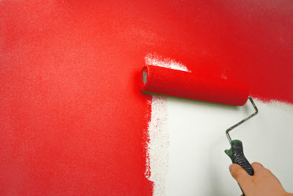 home painters in Boone applying red paint with a roller