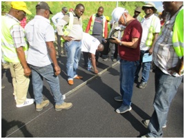 OJT training on pavement construction management to check the flatness after paving asphalt.