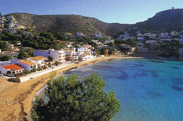Playa del Portet de arena fina y dorada intercalado con zonas de roca en los extremos.uenta con galardón de Bandera Azul, socorrismo, vigilancia, lavapiés, aseos públicos limpios y pasarelas de acceso.