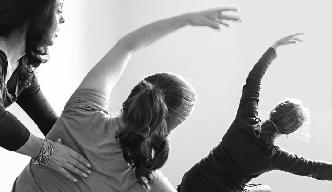 Pilates Instructor guiding clients through weight training and stretching for shoulder and upper back issues on a Pilates Reformer at STUDIO ORIGIN Pilates in Newberg Oregon. 