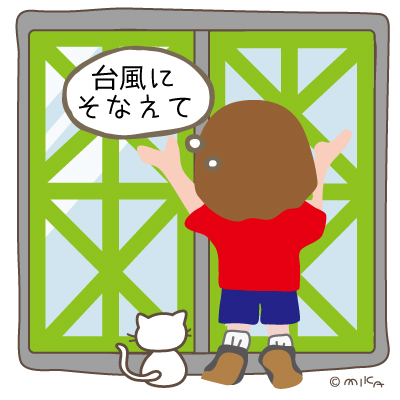 窓に養生テープを貼る女性