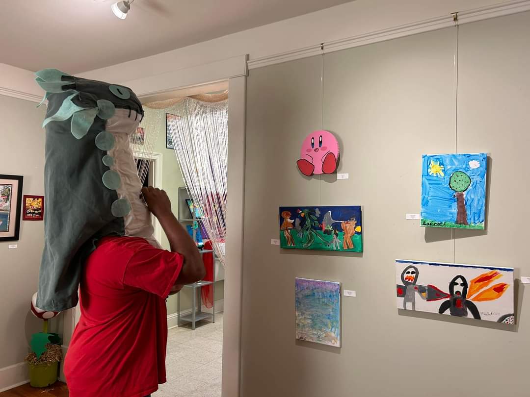 Tavian Bell views the artwork in our Mario-inspired room with works by Ashley Partin, Lorelei Hooper, Violet Clement, & Eydan Clopton