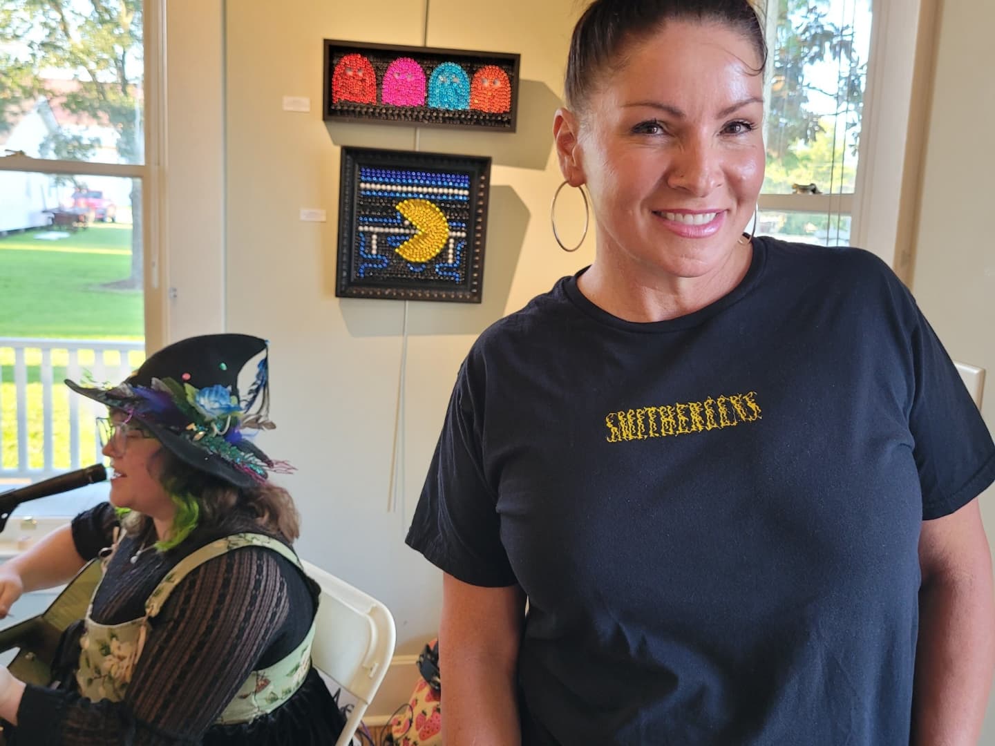 Angelle Boyette poses with her PacMan art on opening night