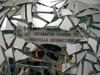 "INFORMANT", broken mirror pieces, metal grid, writing „INFORMANT“ printed on thin acrylic paint surfaces, silicone, double sided, 48.5 x 7.8 in, ICW, 2010
