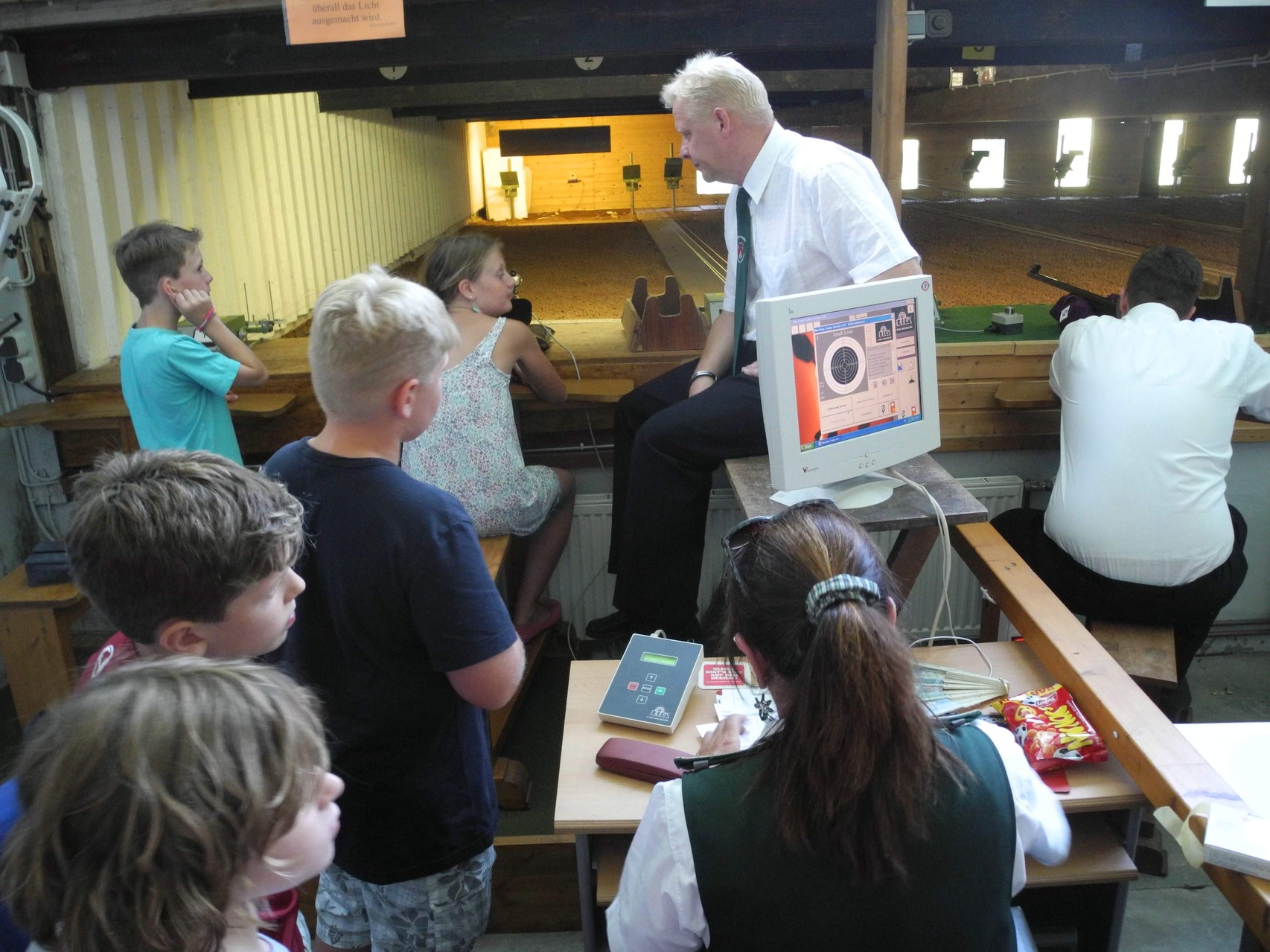 Kinderkönigsschießen mit dem Lichtpunktgewehr. Schützenbruder Dirk Adomeit beaufsichtigt das Schießen