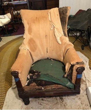 Chair with leather removed showing horsehair and  cotton stuffing and broken leg / 革が剥がされた椅子。馬毛と綿の詰め物、そして折れた脚が見える