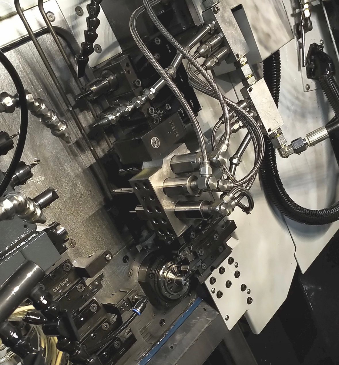 Cooling nozzles for sliding headstock lathes