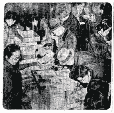 【図版5】 「戦争絵葉書で慰問の速射砲」 （写真は慰問文にペンを走らせる人々）『読売新聞』 1943 年3 月13 日