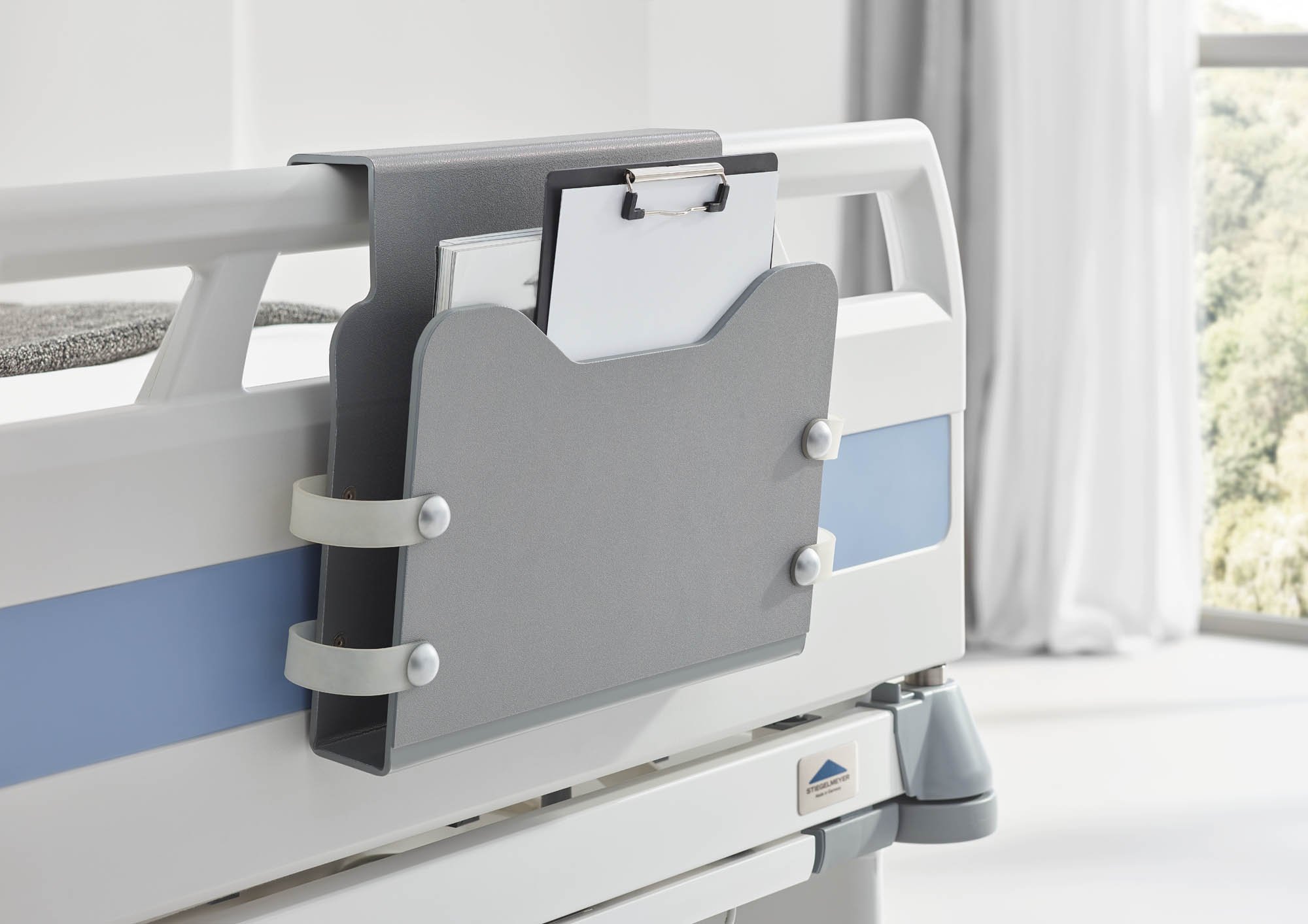 Die Dokumentenhalterung im modernen Farbton Argentum passt gut zu jedem Bett.