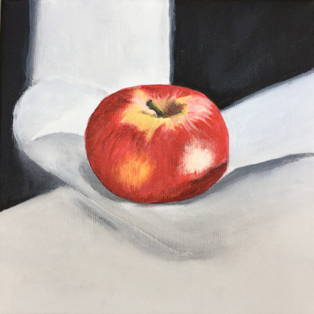 Apfel auf weissem Tuch