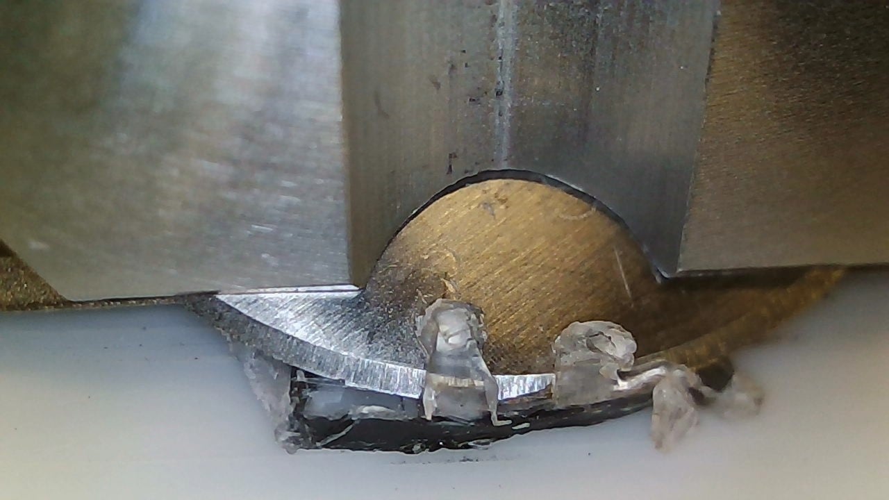 Close-Up of Blade Cutting Through PET Bottle Screw Closure