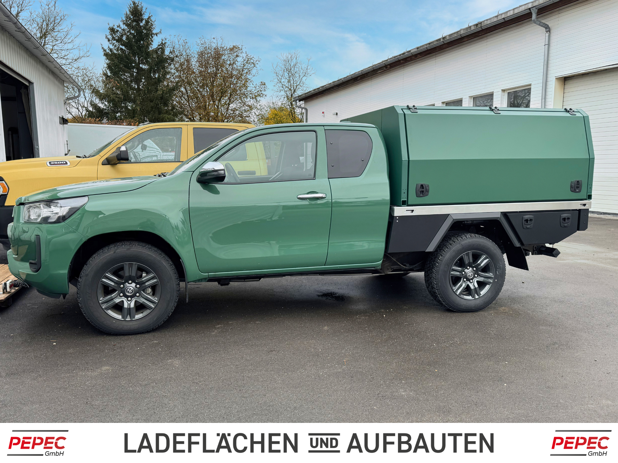 Toyota Hilux Extra Cab mit PEPEC Festaufbau in Wagenfarbe und Unterbau mit seitlichen Toolboxen für flexiblen Einsatz