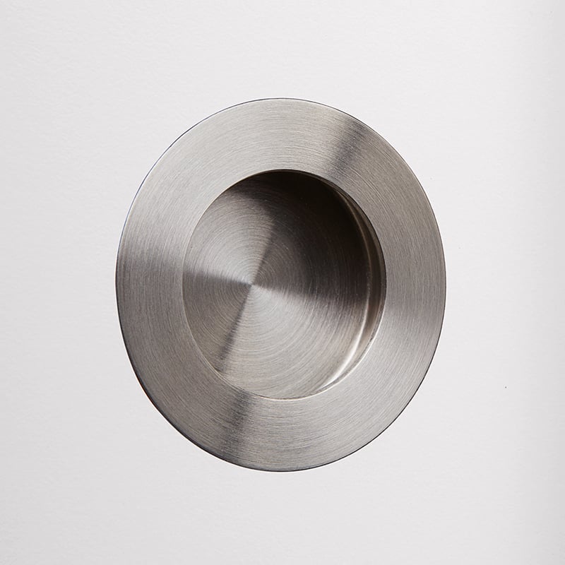 Recessed grip Ø 6.5 cm, brushed stainless steel.