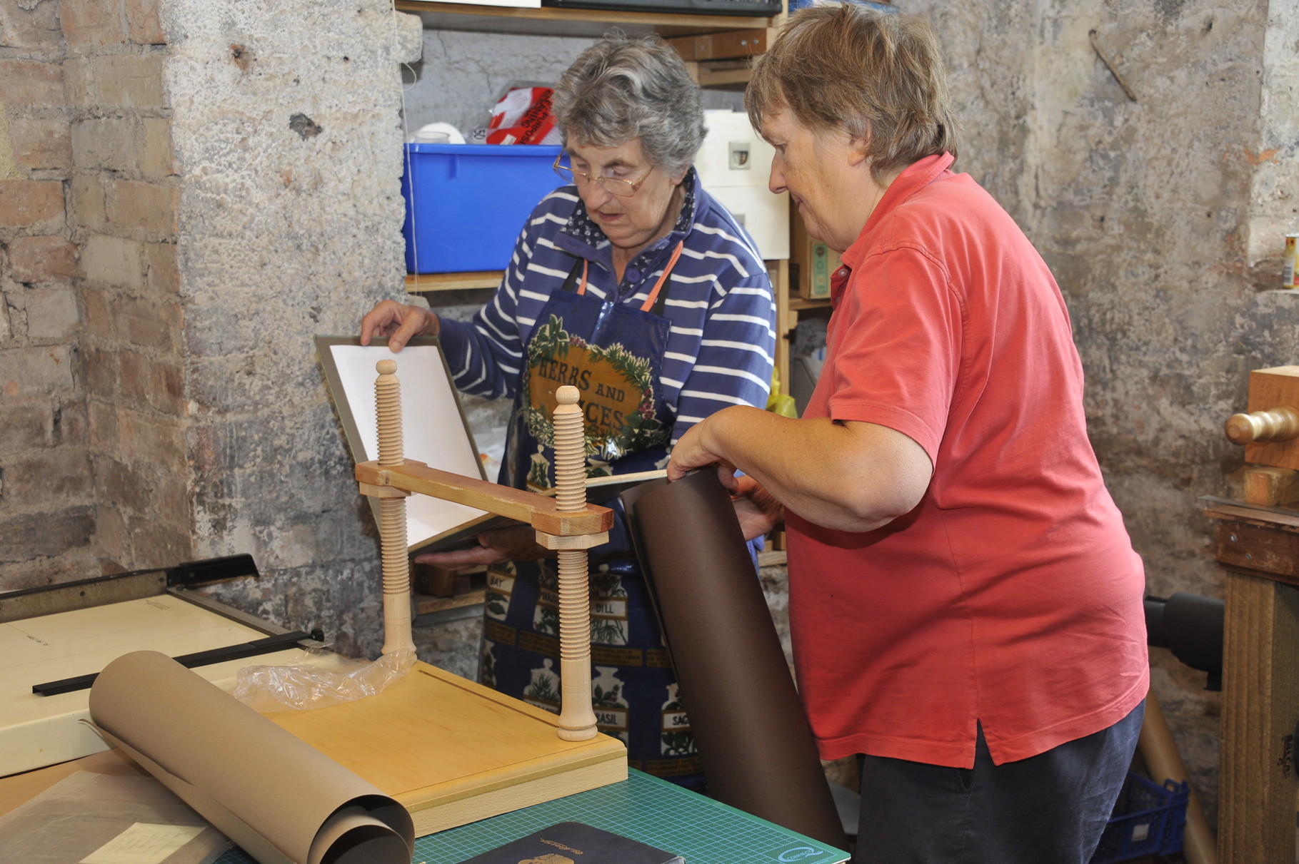 Members of the bookbinding team lovingly restore worse-for-wear books at our very own bindery...