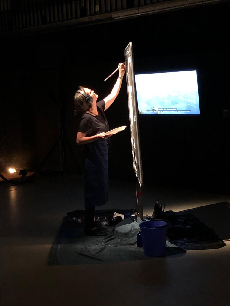 Marianne Iten Thürig "destroying" the poster Salome II of the artist Denys Shantar.