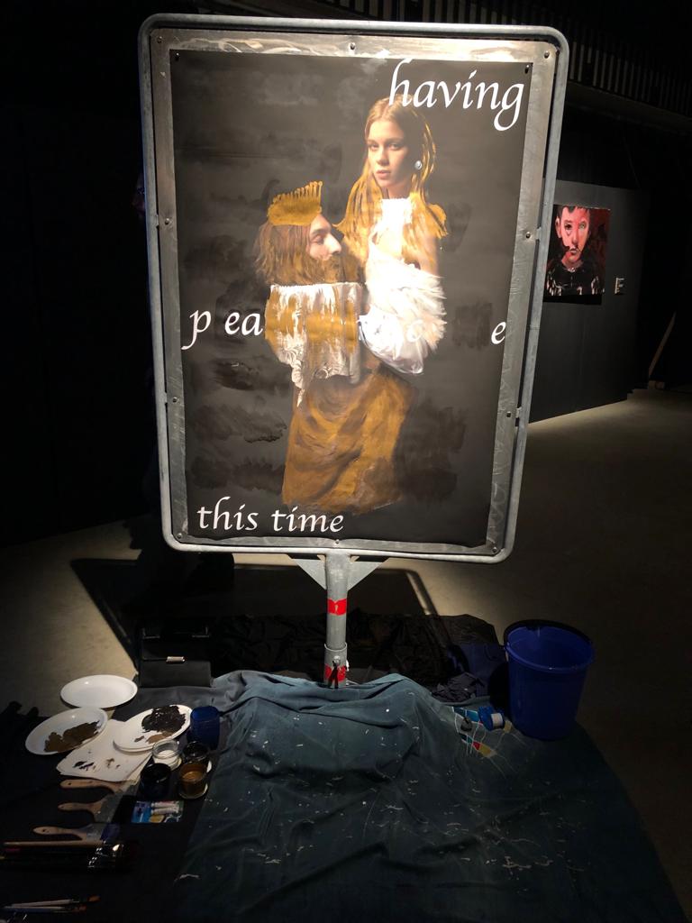 Marianne Iten Thürig "destroying" the poster Salome II of the artist Denys Shantar.