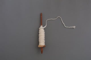 ▲スピンドルを使って双糸に　「きほんの糸紡ぎ」（誠文堂新光社）より　撮影：公文美和