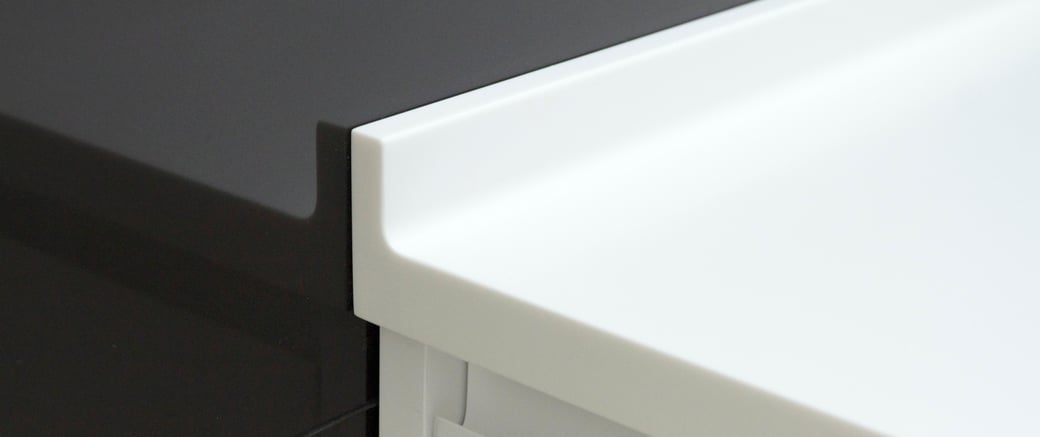 Solid surface bathroom vanity with an elevated edge from water droplets can be joined seamlessly