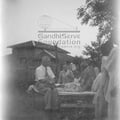 Mahatma Gandhi with foreign visitors on the campus of Sevagram Ashram, c. 1945.