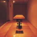 The Law of Relativity, 1999, wooden table, bearings, man’s shoes, woman’s shows, motors, censor, and transformer,