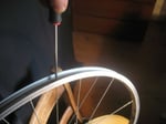 Unscrew bicycle spokes.